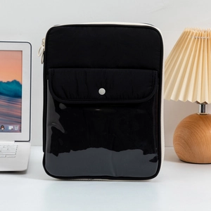 Vertical black laptop sleeve with quilted fabric and glossy patent leather detail