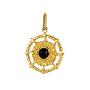 Close-up of golden round pendant with black gemstone and intricate sunburst pattern