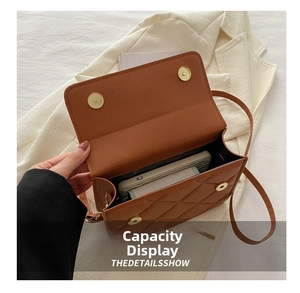 Interior capacity of brown quilted crossbody bag showing space for a smartphone
