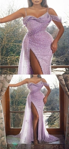 Detail of purple sequin evening gown showing slit hem and shimmering texture