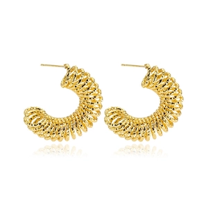 Detailed macro view of gold spiral C-shape earrings with a polished metallic finish
