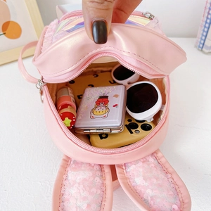 Pink cartoon bunny backpack with sequin ears and clear front pocket showing inner storage