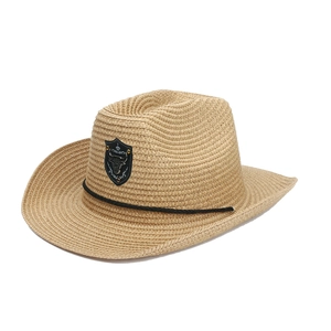 Western straw cowboy hat with bull emblem and decorative black rope on a white background