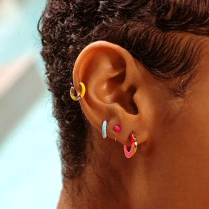 Close-up of model wearing colorful enamel S925 silver hoop earrings and stud combinations