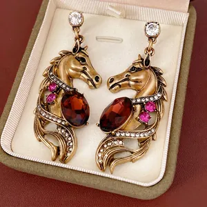 Vintage gold horse head earrings with oval red gemstone and crystal rhinestones