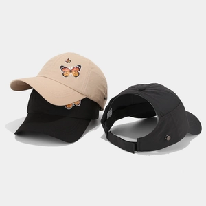 Detail of embroidered butterfly pattern on a breathable ponytail baseball cap