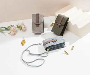 Detailed view of quilted mini phone bags in grey, army green and blue with adjustable straps