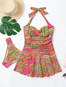 Flat lay of a two-piece floral paisley tankini with halter neck and ruffled skirted hem