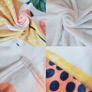 Macro detail of soft flannel blanket showing dense fleece texture and neat edge stitching