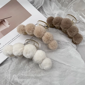 French style plush hair clips in beige, brown, and white on soft white fabric