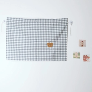 Detail view of checkered car window sunshade with 3D plush bear and suction cup