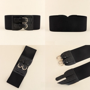 Detail of black elastic wide waist belt for women with dual golden pin buckle and texture