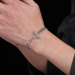 Silver cuban chain bracelet with OT toggle clasp on wrist, stainless steel male jewelry