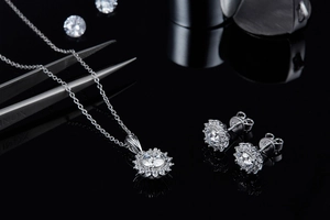 Macro shot of silver sunflower jewelry set with sparkling moissanite halo necklace and earrings