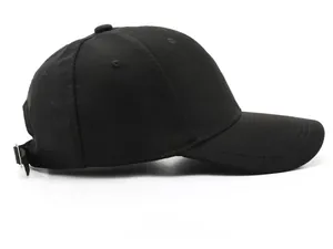 Detailed side view of black cotton baseball cap showing curved brim and stitching