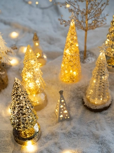 Close-up of glass Christmas tree with LED lighting and warm festive golden textures