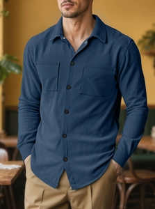 Detail of blue corduroy men shirt with texture fabric and double chest pockets