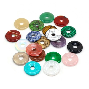 Variety of polished natural crystal donut pendants in malachite, agate, and turquoise colors
