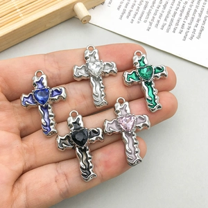 Set of 5 alloy cross pendants with colorful enamel and heart gems held in hand