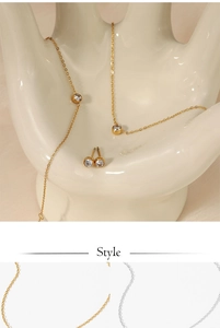 Detailed set of gold minimalist jewelry including zircon necklace bracelet and stud earrings