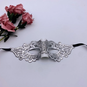 Silver lace masquerade mask with black ties and decorative pink flowers on white background