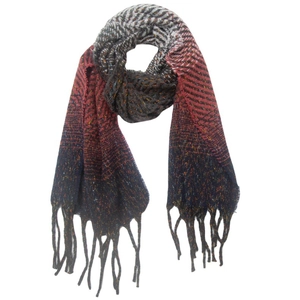 Detail of herringbone knit scarf with red, grey and blue gradient tones and fringe edges