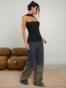 Slim fit black halter neck top paired with gradient wash wide leg denim jeans