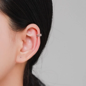 S925 sterling silver heart ear cuff with hollow design worn on model's cartilage