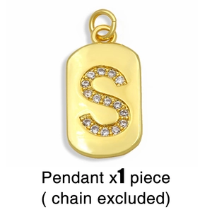 Detailed close-up of a golden S letter pendant inlaid with sparkling white cubic zirconia stones