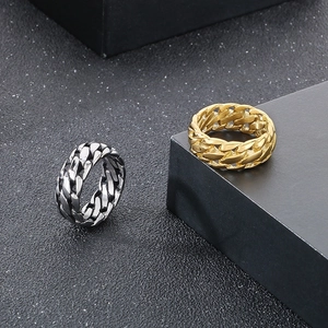 Detail shot of Cuban chain style rings in silver and gold finishes on black backgrounds