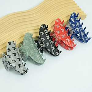 Set of glittery butterfly hair claws in silver, green, black, red, and blue colors