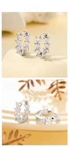Detailed view of silver hoop earrings with heart-cut cubic zirconia in a split display