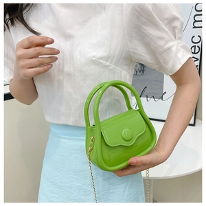 Vibrant bright green mini crossbody jelly bag with shiny finish and gold chain strap
