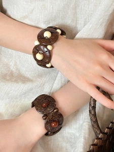 Close-up of bohemian coconut shell beaded bracelets featuring brown discs and colorful beads