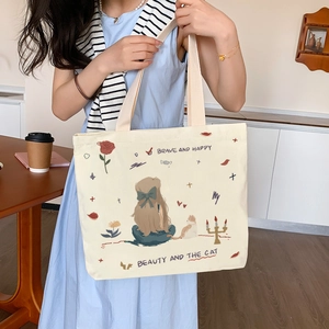 Minimalist beige canvas tote bag with cat illustration and comfortable shoulder strap