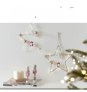 Light-up Christmas star hanging decorations with small figurines and warm glow
