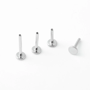 Detailed macro view of G23 titanium flat back studs with internal threading for piercings