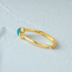 Macro shot of S925 sterling silver stamp on golden turquoise ring inner band