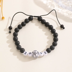 Macro detail of 2026 World Cup theme braided bracelet with football bead and matte finish