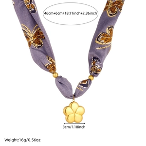 Detail of purple butterfly print silk ribbon necklace with gold flower charm and beads