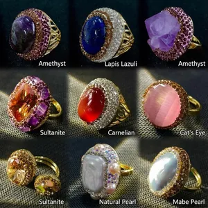 Vintage gold rings set with amethyst, pearl, and gemstones in a bohemian style display