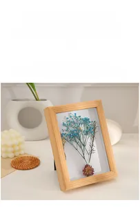 Detail of solid wood deep shadow box frame showcasing dried flowers and natural grain texture