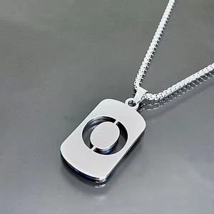 Detail of silver titanium steel necklace featuring a rectangular hollow tag pendant