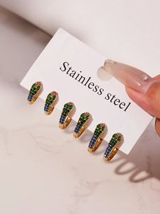 Detailed view of six gold-plated stainless steel U-shaped earrings with colorful zircons