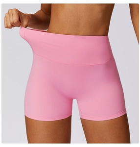 Close-up of pink high-waisted yoga shorts featuring seamless fabric and tummy control belt