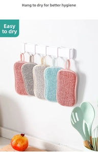 Five-piece multi-color dish sponges hanging on a kitchen rack to dry quickly