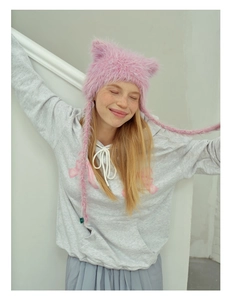 Detailed view of pink fuzzy cat ear beanie with pom pom earflaps and grey ribbon hoodie