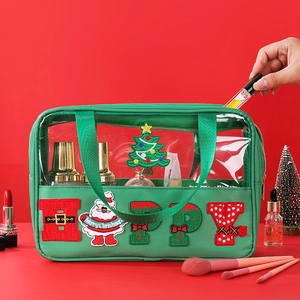 Detail of green transparent cosmetic bag with festive Christmas embroidery and toiletries