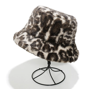 Detailed view of leopard print faux fur bucket hat on a display stand showing soft texture