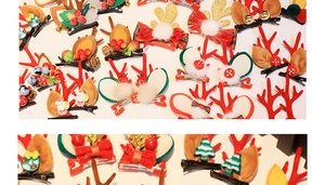 Close-up of festive Christmas hair clips featuring plush reindeer antlers and Santa motifs